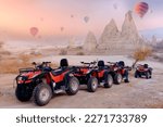 Small photo of Safari trip ATV quad bike with set colorful hot air balloon in Cappadocia Goreme Turkey.