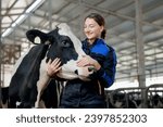 Happy young woman farm worker hugging cow as sign of concern for animal health care. Concept agriculture cattle livestock farming industry.