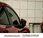 Small photo of Jakarta, 13 May 2023 - A man parked his red mazda 2 (DJ) sedan (DL) outside a pharmacy building in Kemayoran, Central Jakarta