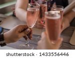 Group of friends having fun and drink rose. Cheers glasses of pink prosecco in the hands. Birthday celebration with friends. Summer mood in Minsk, Belarus.