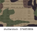Military steel bodywork painted khaki metal plates mounted with rows of rivets and bolts, with small details. The photo has a copy space in the center. Background for army design postcard. 