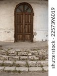An Old Arched Wooden Door In...