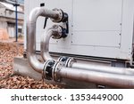 Industrial stainless steel pipes connected to the commercial cooling unit for the HVAC systems