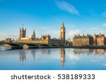Big Ben and Westminster parliament with colorful sky and water reflection