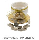 Small photo of The ceramic bowl, filled with loose change, sits elegantly on a pine wood lid against a white background. The fallen coins add a playful and spontaneous touch, transforming the object into a decor ful