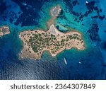 Aerial top down view of the little island Ydrousa off the coast of Voula, south Athens, Greece, with turquoise sea