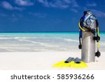 Scuba diving equipment on a tropical beach