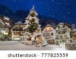 The market place of Hallstatt, Austria, with a Christmas tree and falling snow in winter time
