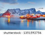 Moskenes island on Lofoten islands archipelago  in Norway over polar circle, Scandinavia, Europe - Lovely dusk scene of Villages Reine and Hamnoy: Reine fjord and snow-capped mountains in background. 