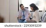 Small photo of Doctor woman holding knee and looking at aged woman patient while explaining. Support for strained muscles. Doctor fixing woman knee with hands
