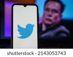 Small photo of Kaunas, Lithuania 2022 April 5: Twitter logo on smartphone and Elon Musk in the background. Elon Musk joins Twitter board