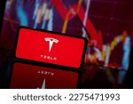 Small photo of Paris, France - 2023 March 13: Tesla company shares go down at stock market. Tesla company financial crisis and failure. Economy collapse
