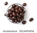Top view of chocolate covered peanuts in glass bowl isolated on white