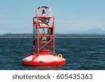 Small photo of red bell buoy close up reflecting sunshine in sea