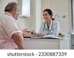 Small photo of Female doctor and professional nutritionist in uniform advise Caucasian patients about supplementary foods and nutrients for healthy diet at clinic hospital, checkups, and appointments.