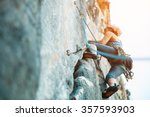 Adult female rock climber on vertical flat wall with poor relief - side view, close-up. 