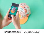 Small photo of young women taking photo to hat with cell telephone or smartphone digital camera for Post to sell Online on the Internet . Customise pastel bright colors tone .