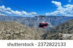 Small photo of A panoramic sweep of Copper Canyon, featuring a cable car adorned with "Bienvenidos a Chihuahua" and "Barrancas del Cobre" welcoming tourists, as they revel in the spectacular landscape below.