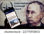 Small photo of Vladimir Putin arrest warrant seen in press release from the International Criminal Court in The Hague. On 19 March 2023 in Brussels, Belgium.