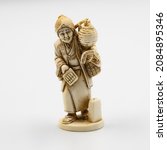Small photo of Ivory Netsuke. A miniature carving or ornamental toggle used to attach a medicine box, pipe, or tobacco pouch to the obi (sash) of a Japanese man's traditional dress.