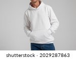 Young male in blank white hoodie front view. Design men  sweatshirt with pocket template and mock-up for branding or print.