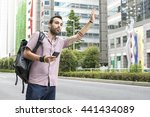 Young White Man Holding Cellphone Hailing Uber Taxi