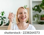 Woman doing self massage with rose quartz face roller