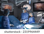 The surgeon's holing the instrument in abdomen of patient. The surgeon's doing laparoscopic surgery in the operating room. Minimally invasive surgery.
