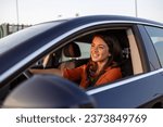 Small photo of Photo of positive cheerful girl funky driver rider enjoy drive ride car under pop star hits playlist music try dance raise hands in city center