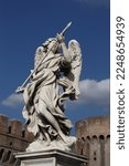 Small photo of statue of an angel with a spear near the castle of the holy angel, Rome, Italy