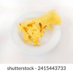 Small photo of Rempeyek or fish crackers on white plate with salt fish or ikan teri isolated on white background. Fried savory Javanese crackers made from rice flour with salted fish by crispy flour mixture.