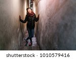 Famous landmark the narrowest street in Prague and maybe even in Europe with posing woman tourist