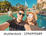 Tourism and holiday resorts - a couple in love during their honeymoon taking a selfie photo in Dubai, UAE