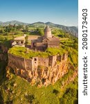 Small photo of Aerial view of scenic Tatev Monastery located on an inaccessible basalt rock with wonderful viewpoint. Travel and worship attractions in Armenia