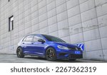 Small photo of Shanghai, China- February 18, 2023: A blue Volkswagen Golf R MK7.5 hatchback is parked in courtyard