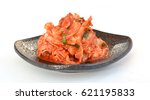 Kimchi on black plate, isolated on white background