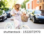 
Attractive elderly woman is cycling on the road in the city