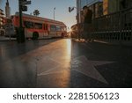 Sunrise on Hollywood Boulevard Walk of Fame as a city Bus drives by
