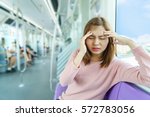 Small photo of Portrait of young woman headache or carsick while taking the sky train