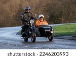 Small photo of Stony Stratford, Bucks, UK, Jan 1st 2023. 1971 classic black Ural motorcycle and sidecar travelling on an English country road