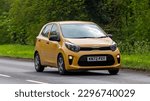 Small photo of Stony Stratford,Bucks,UK - April 30th 2023. 2022 yellow KIA PICANTO small hatchback car travelling on an English country road.
