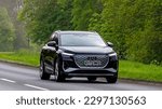Small photo of Stony Stratford,Bucks,UK - April 30th 2023. 2022 black AUDI Q4 E-TRON S LINE 35 electric car travelling on an English country road.