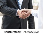 Small photo of Businessman is shaking hand with woman , focus at hand.shake hands, When you shake hands with somebody, you must look him in the eye. shake hands
