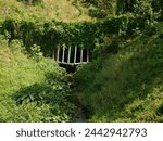 Small photo of Rectangle metal Steel grille of drainage pipe cover over culvert pipes