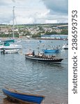 Small photo of Teignmouth, England – July 21, 2023: The year round passenger ferry dating back to the thirteenth century that plys between the town and Shaldon on the opposite banks of the river Teign