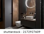 Modern bathroom with rusty tiles, stylish lighting and elegant decorations