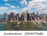 Aerial panoramic city view of Lower Manhattan area over East River, New York City, USA. Bird's eye view from helicopter of metropolis cityscape. A vibrant business neighborhood.