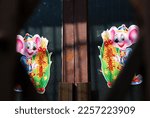 Small photo of Ningbo, Zhejiang Province, China - 01 09 2006: Micky mouse like cartoon on the rustic doors for Chinese New Year(Year of Mouse)
