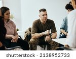 Small photo of Mid adult veteran attending group therapy session at mental health center.