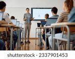 Small photo of Computer science teacher giving a lecture to her high school students in the classroom.